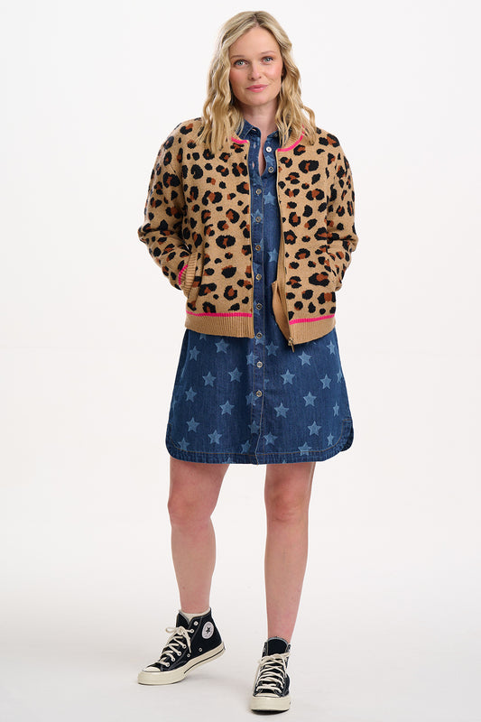 Knitted bomber jacket from Sugarhill Brighton, featuring bold black leopard spots on a tan background and bright pink tipping along the hem, the cuffs and the neckline. With a zipper closure and side pockets. Made from 40% Polyester, 35% Acrylic, 25% Nylon.