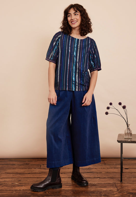 Festive top from Emily and Fin. Vertical lurex stripes of various with in blue, fuchsia and gold on a navy background. Boatneck, 1/2 sleeves. Made from cotton.
