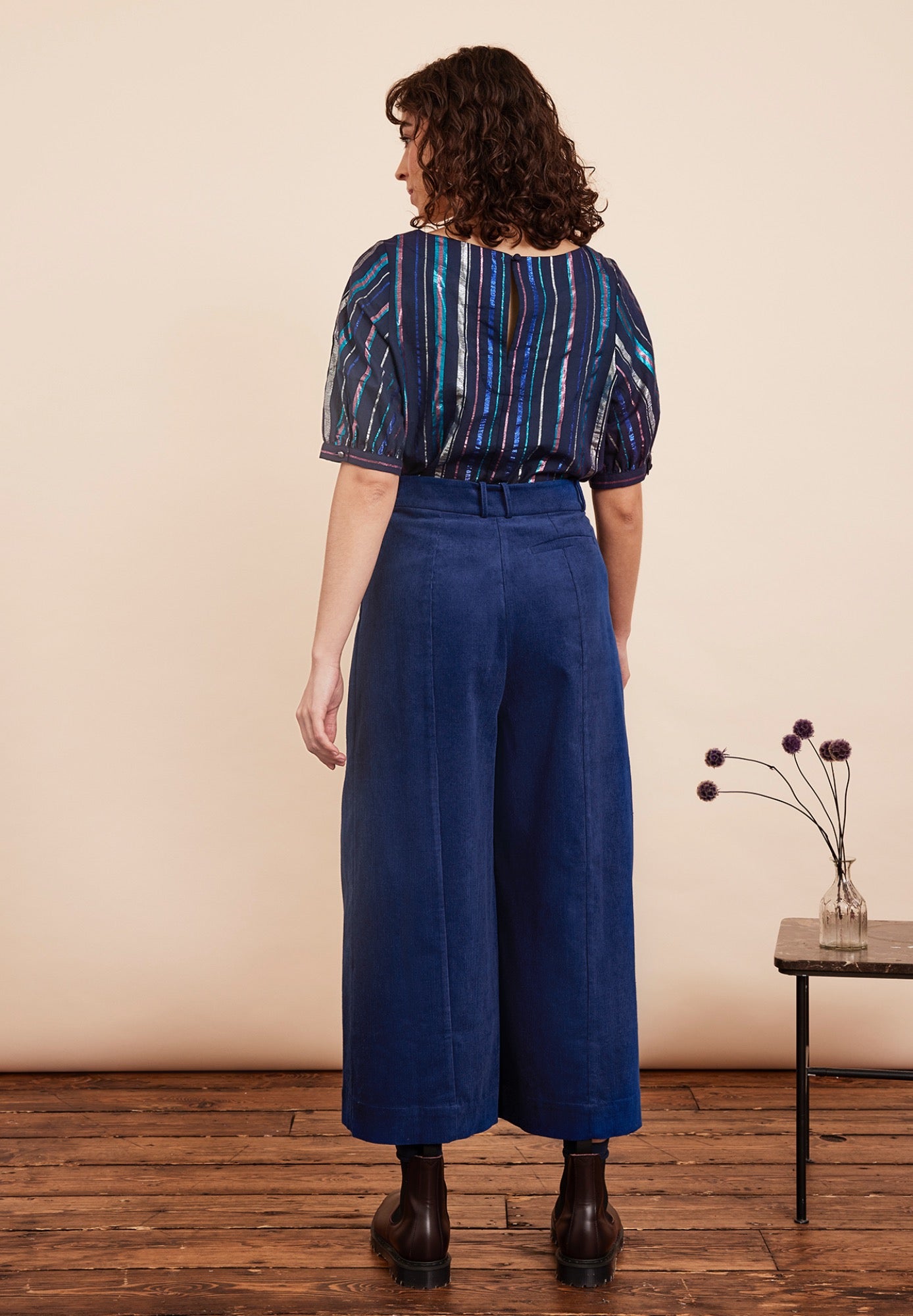 Festive top from Emily and Fin. Vertical lurex stripes of various with in blue, fuchsia and gold on a navy background. Boatneck, 1/2 sleeves. Made from cotton.