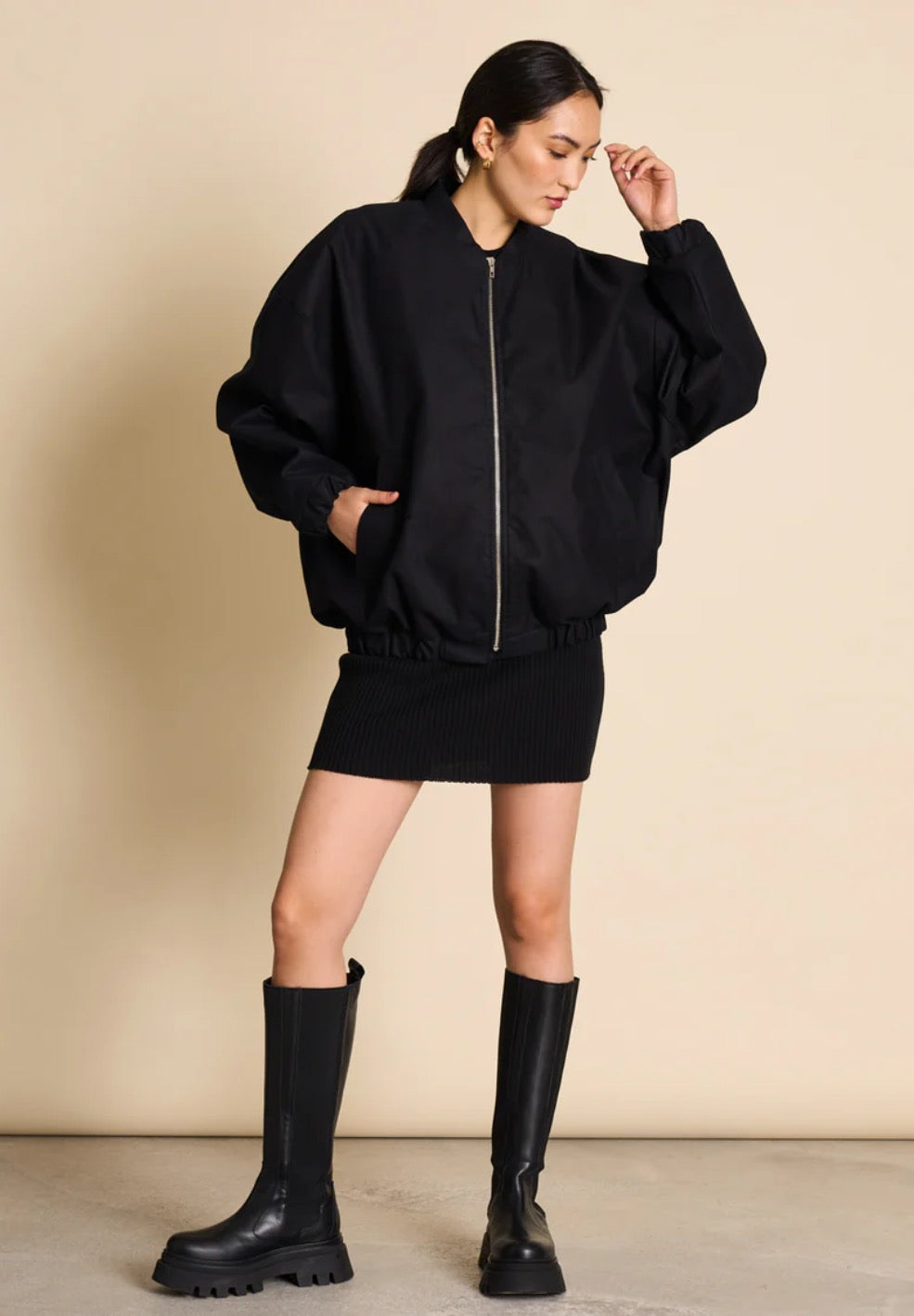 Bomber jacket by Jan n June. Oversized unisex fit. Long sleeves, bomber collar and zipper closure. Lined. Made from sustainable organic cotton. In black.