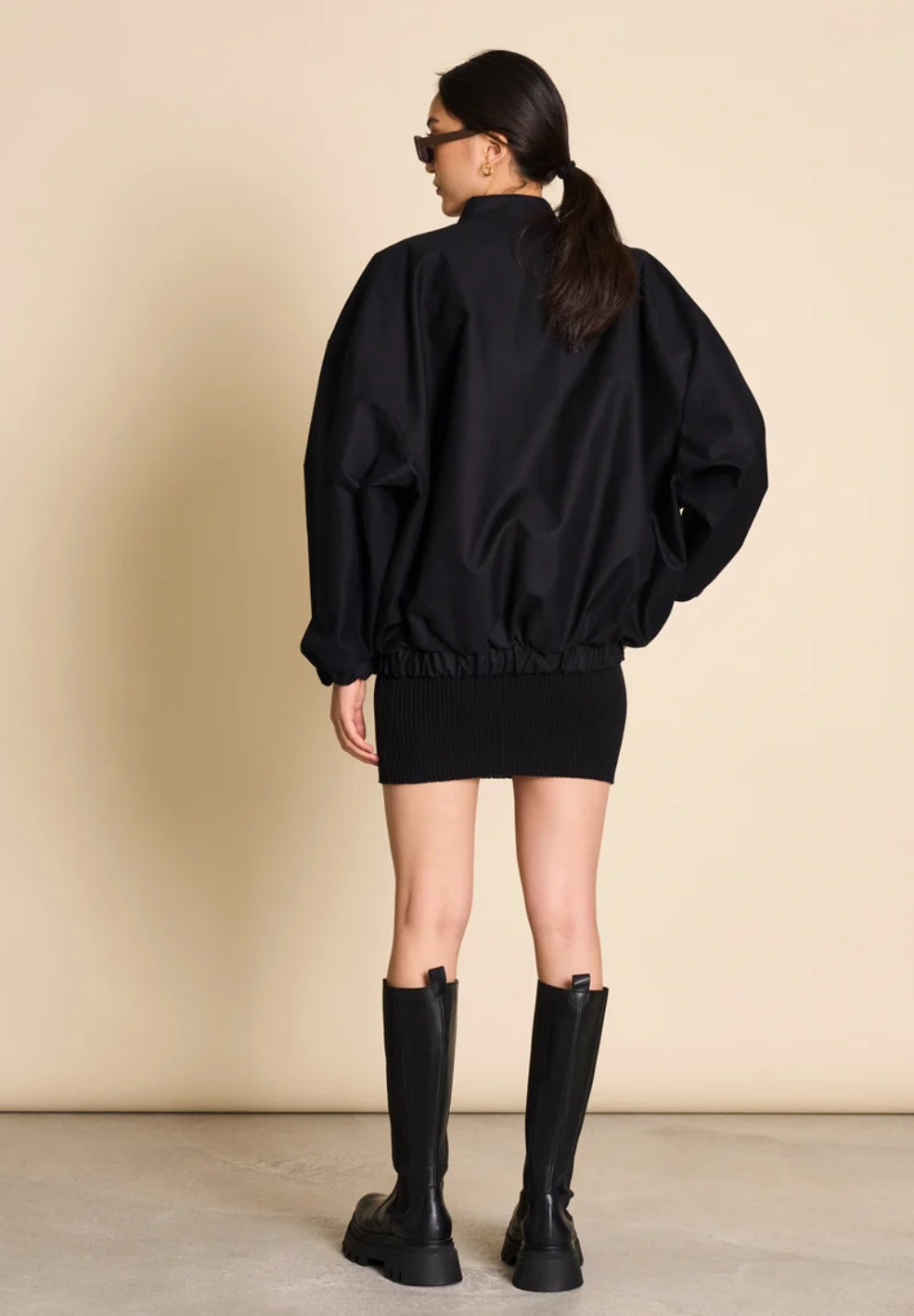 Bomber jacket by Jan n June. Oversized unisex fit. Long sleeves, bomber collar and zipper closure. Lined. Made from sustainable organic cotton. In black.