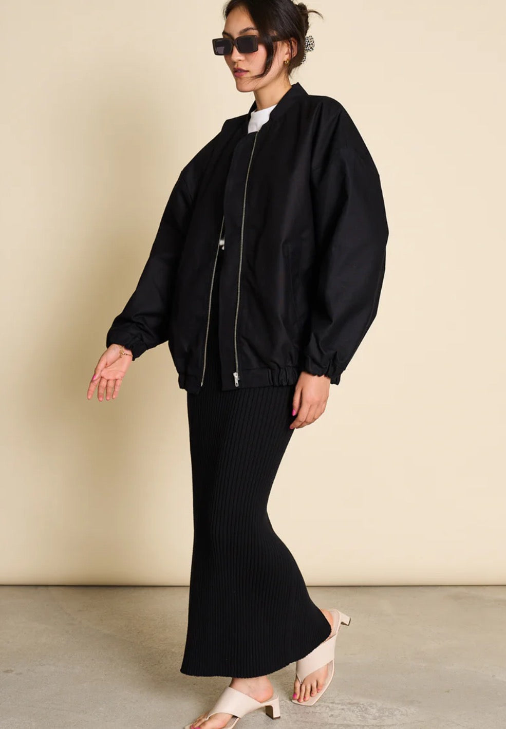 Bomber jacket by Jan n June. Oversized unisex fit. Long sleeves, bomber collar and zipper closure. Lined. Made from sustainable organic cotton. In black.