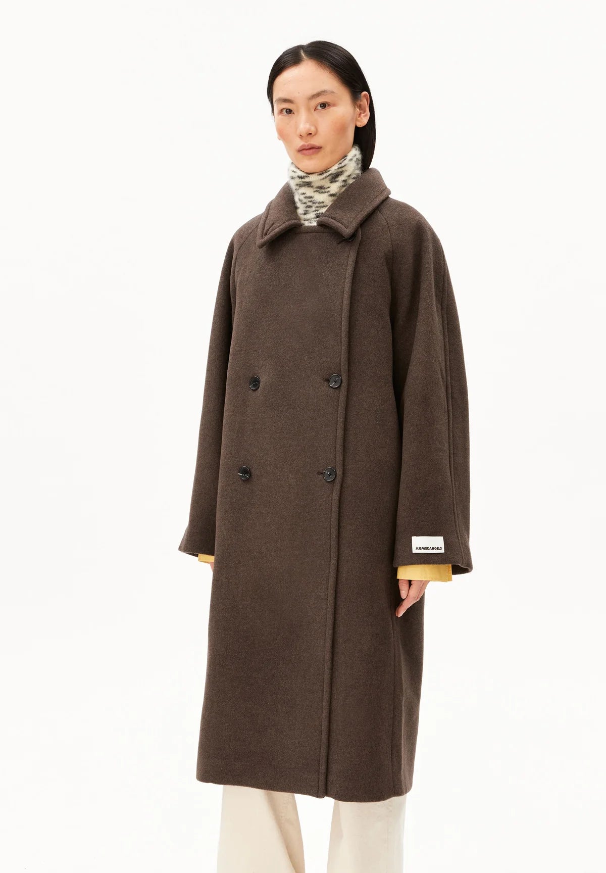Woman wearing a brown woolen coat on a white background