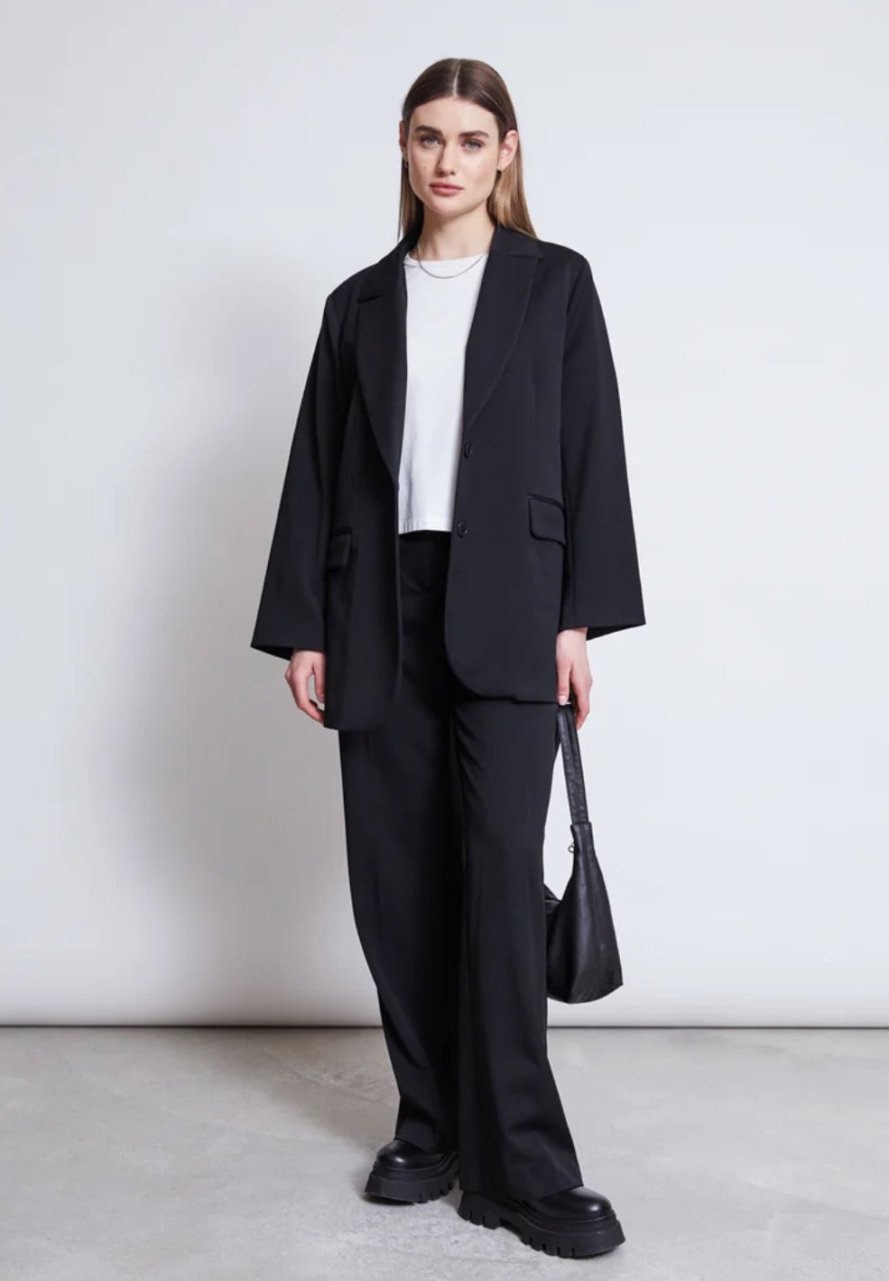 Black suit jacket by Jan n June. Oversized fit. Button closure, front pockets. Made from sustainable recycled polyester.