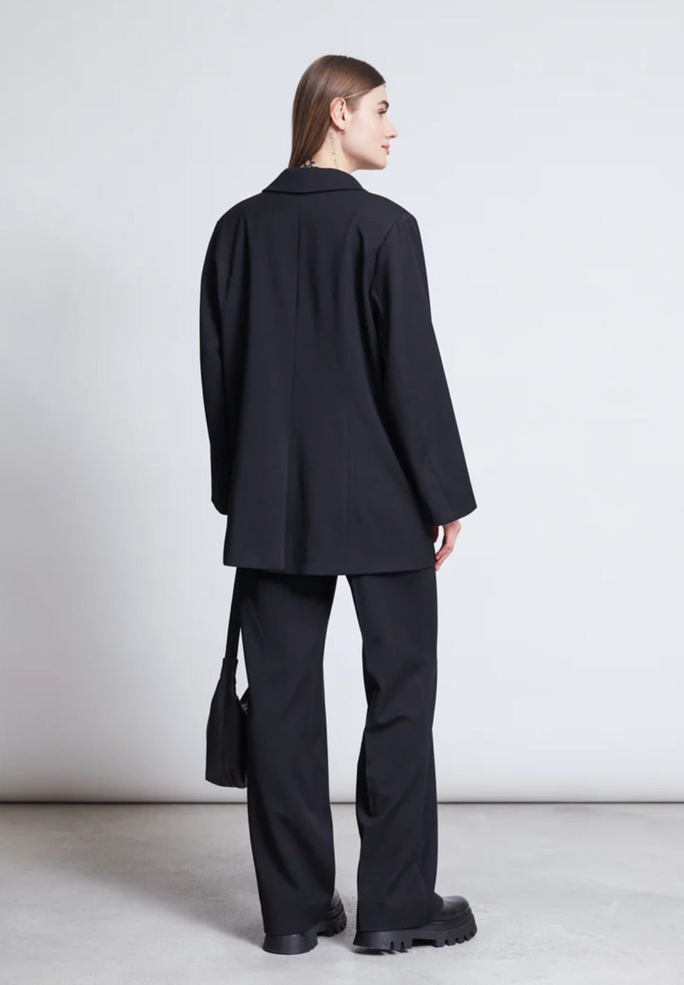 Black suit jacket by Jan n June. Oversized fit. Button closure, front pockets. Made from sustainable recycled polyester.