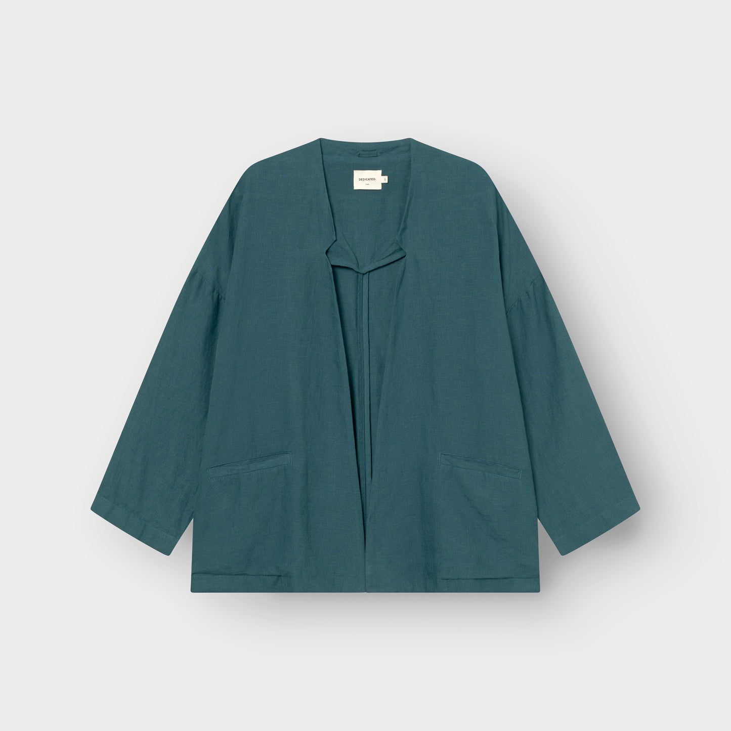 Teal linen jacket on a light gray background