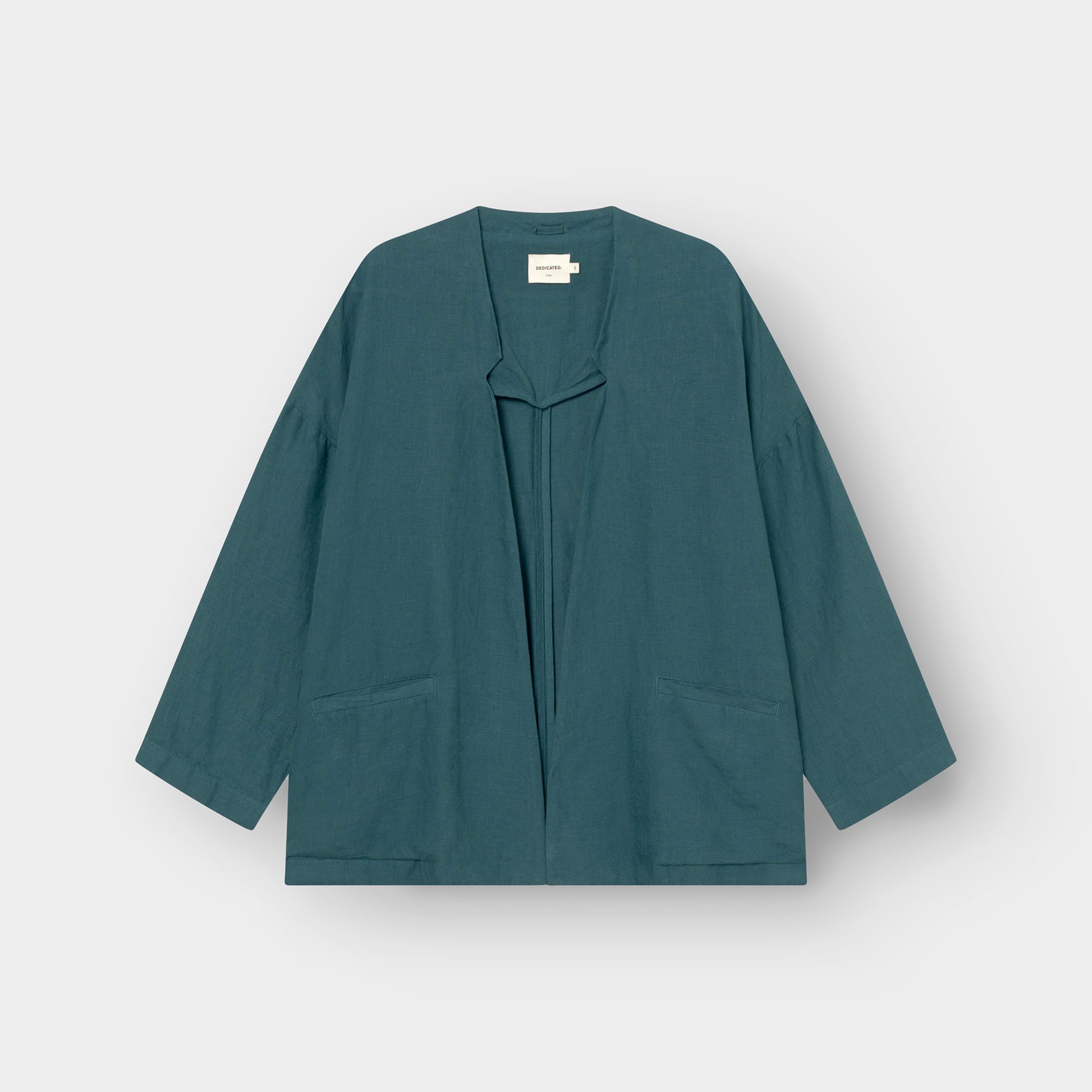 Teal linen jacket on a light gray background