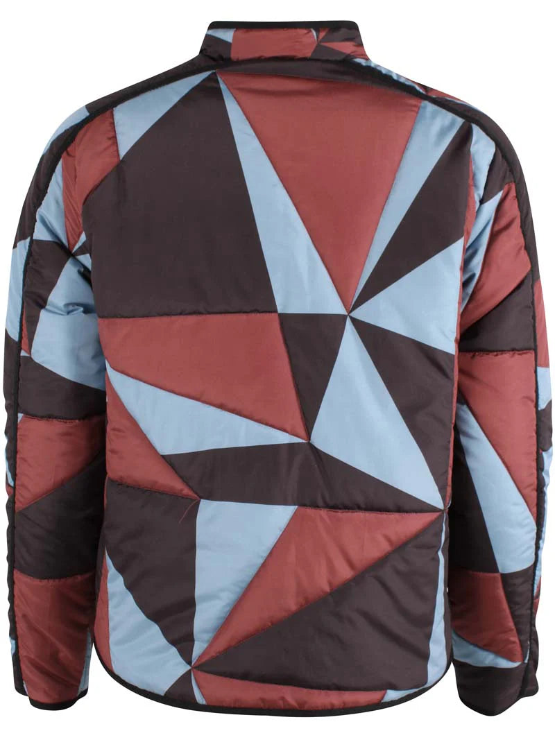 Woman wearing a thermal jacket from Danefae, featuring a geometric pattern in ice blue, wine red and black, and green beanie on a white background