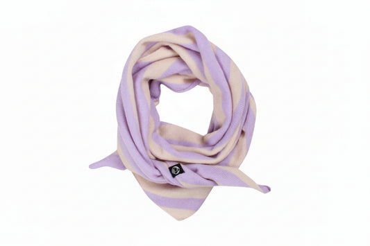 A soft knit scarf by Danefae with alternating horizontal stripes of light lavender purple and cream, styled in a loop on a solid white background. A small black square logo tag is attached near the bottom.