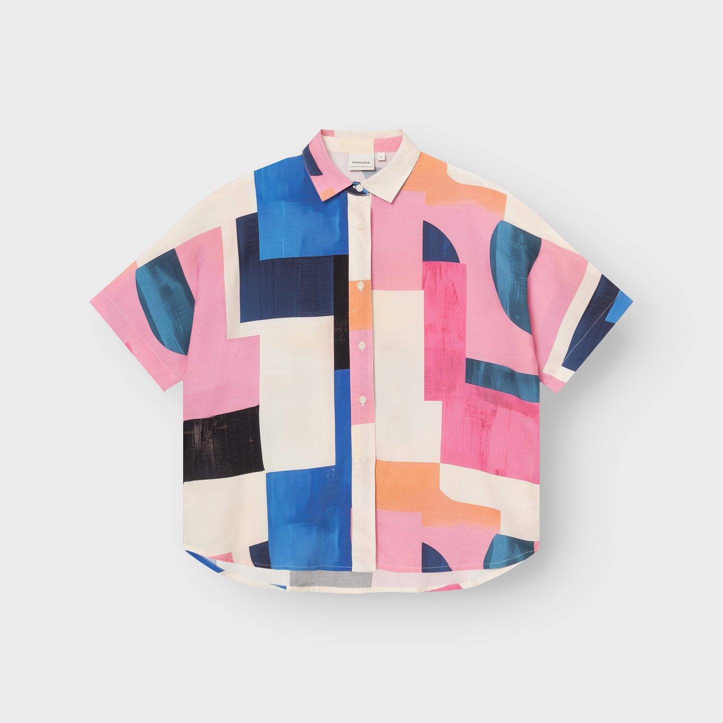 Colorful geometric patterned shirt on a light gray background