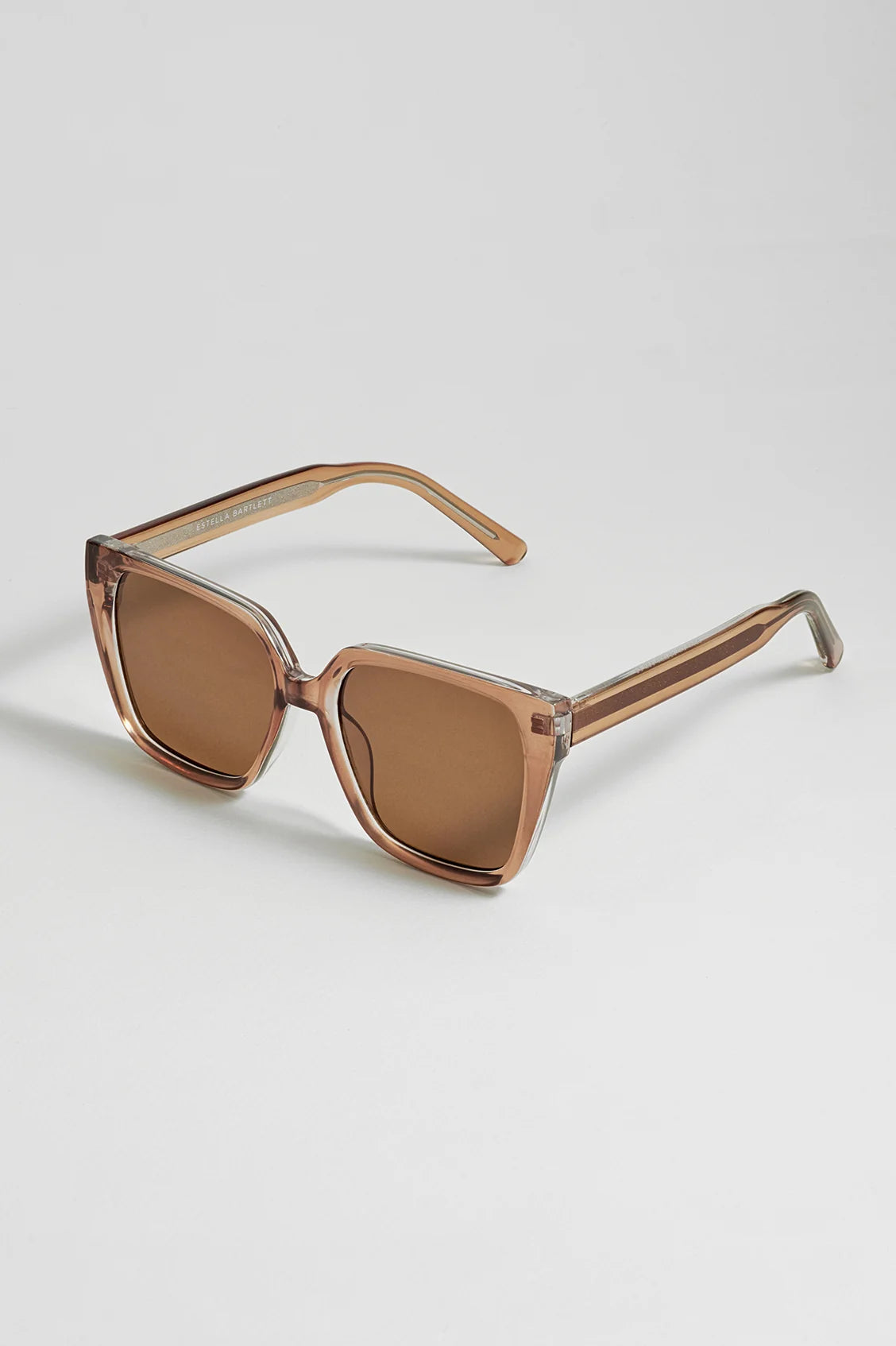 Brown sunglasses on a light gray background
