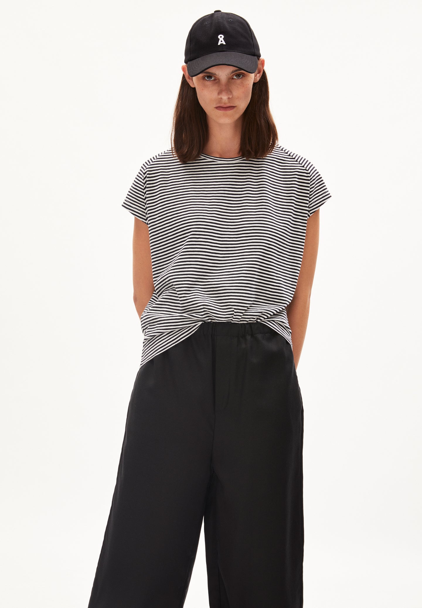 Loose fit striped t-shirt from Armedangels, with cap sleeves and a round neck, fine horizontal stripes in oat milk white and black, made from sustainable organic cotton.