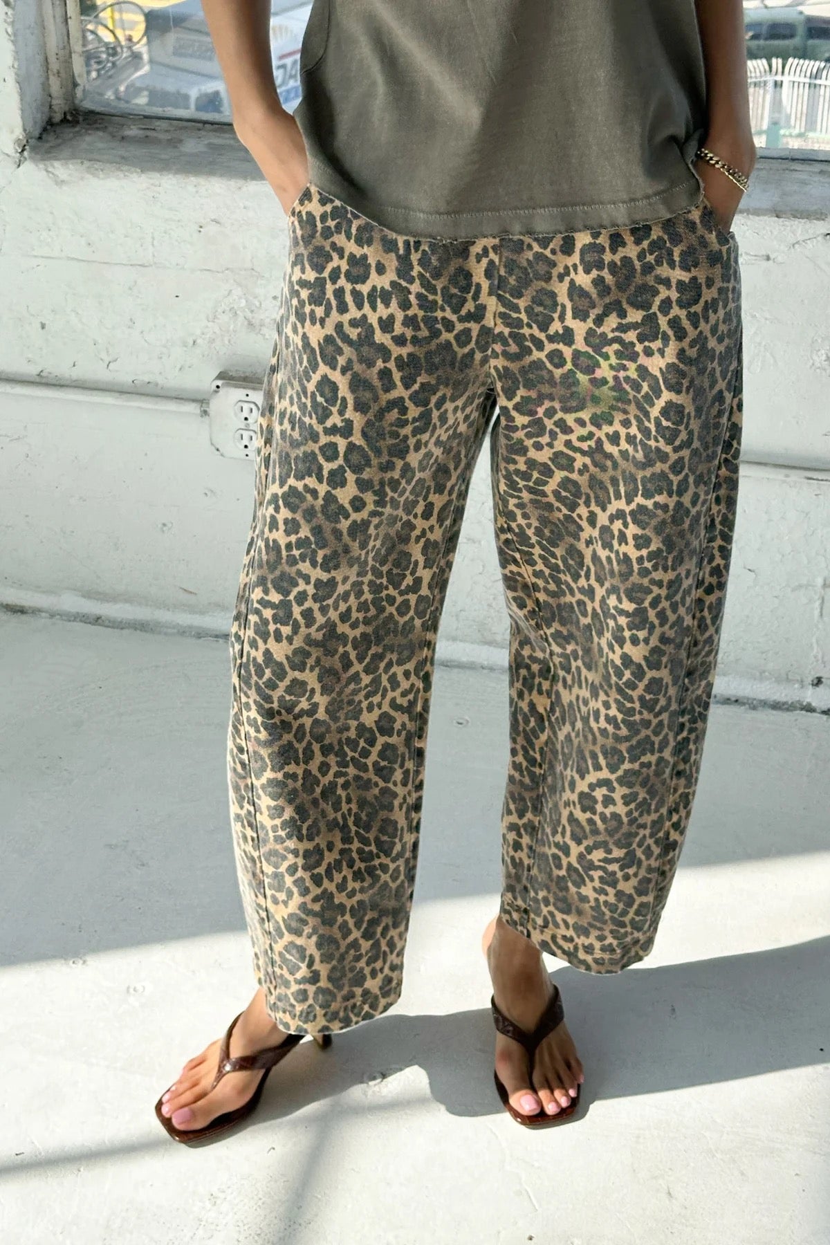 Arc Pants from Le Bon Shoppe. Barrel leg jeans with an elastic high waist and a slightly curved, cropped leg. Made from pure cotton canvas with a leopard print. With deep side pockets.