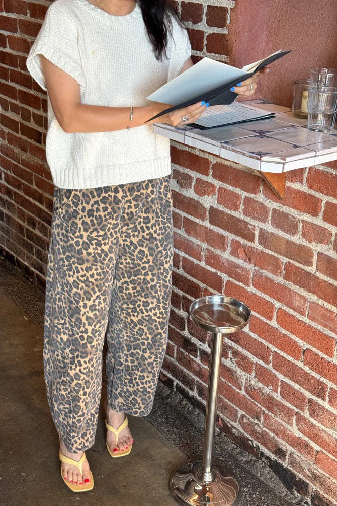 Arc Pants from Le Bon Shoppe. Barrel leg jeans with an elastic high waist and a slightly curved, cropped leg. Made from pure cotton canvas with a leopard print. With deep side pockets.