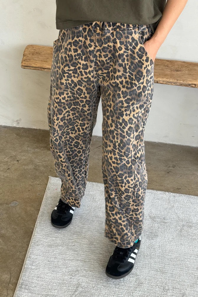 Arc Pants from Le Bon Shoppe. Barrel leg jeans with an elastic high waist and a slightly curved, cropped leg. Made from pure cotton canvas with a leopard print. With deep side pockets.