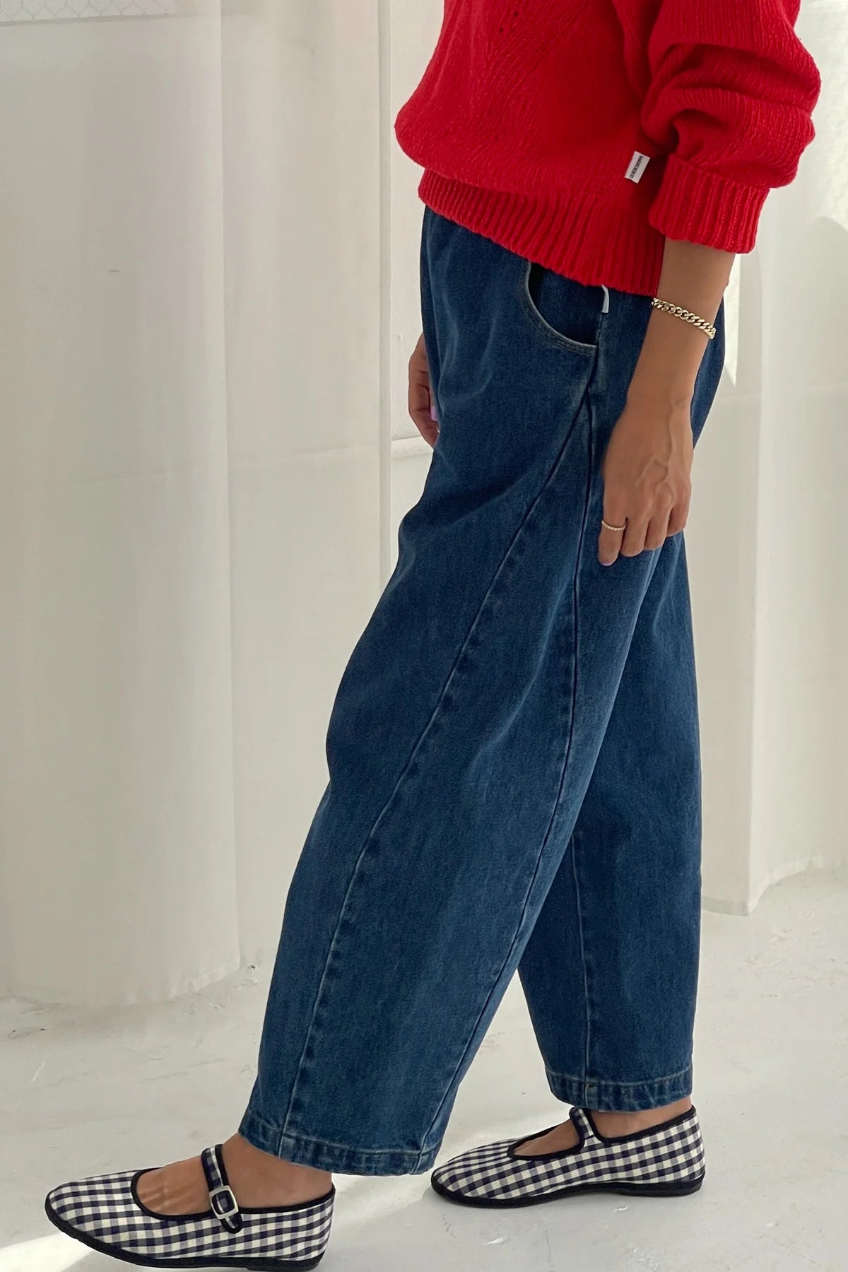Arc Pants from Le Bon Shoppe. Barrel leg jeans made from durable 100% cotton denim. Featuring an elastic high waist, deep side pockets, and a slightly curved, cropped leg with a unique side panel. In a mid denim blue colour.