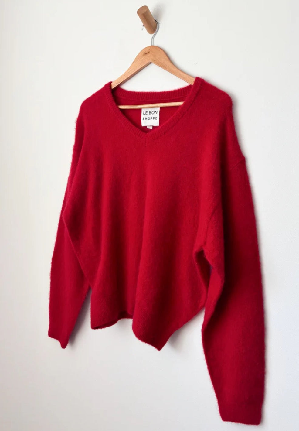 Bright red knitted mohair blend jumper from Le Bon Shoppe shown hanging on a hanger 