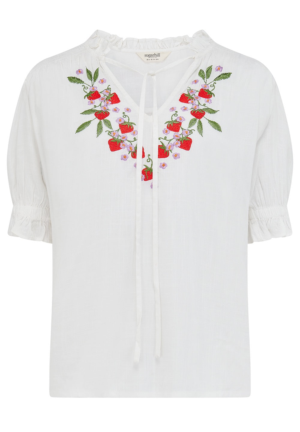 White blouse with floral embroidery on a white background