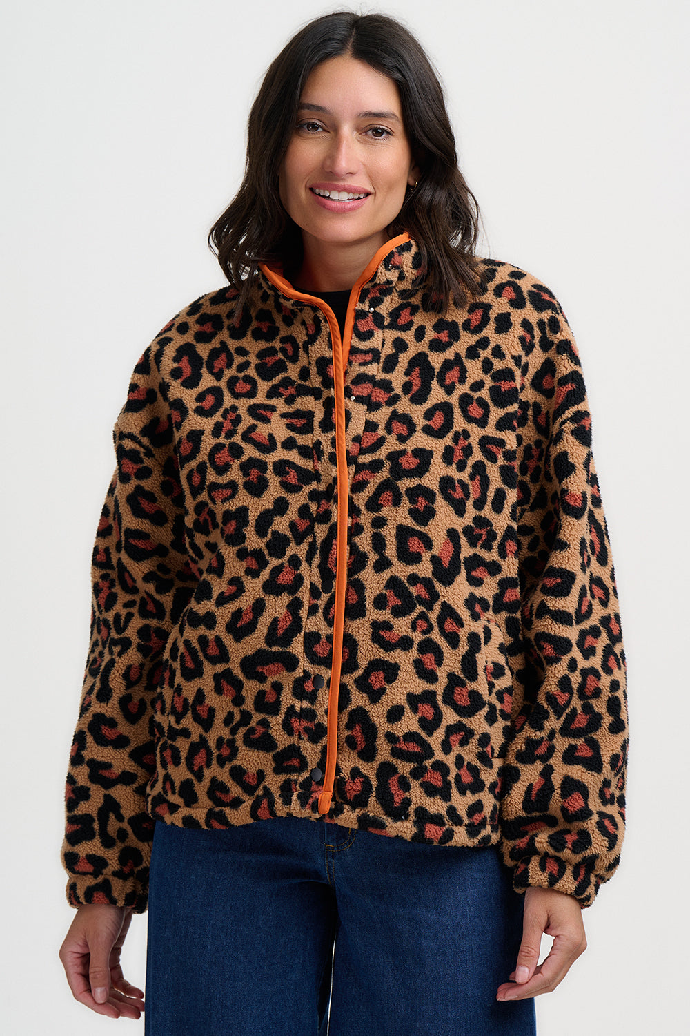 Woman wearing the Remi leopard print jacket from Sugarhill Brighton with an orange zipper on a white background