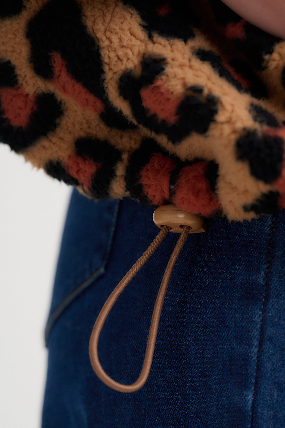 Leopard print fabric with a keychain attached on a white background