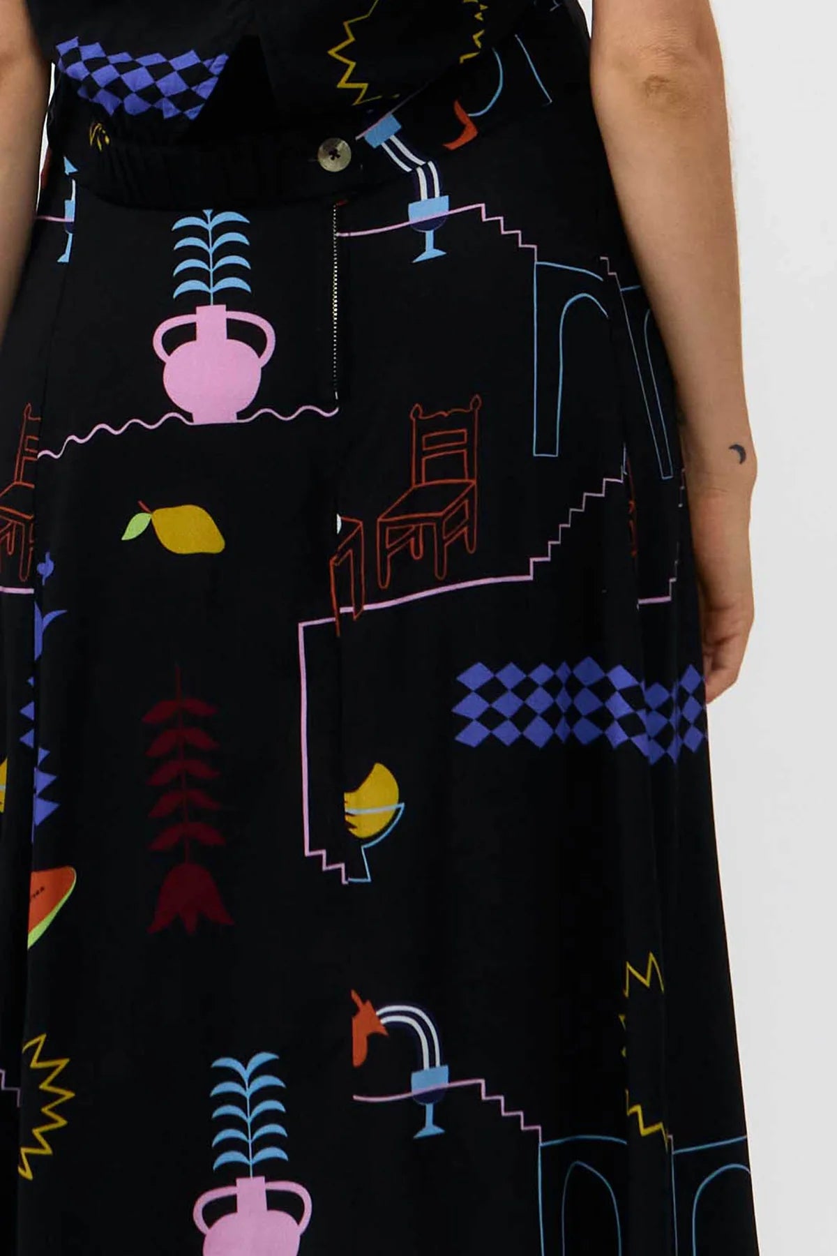Black skirt with colorful abstract patterns on a white background