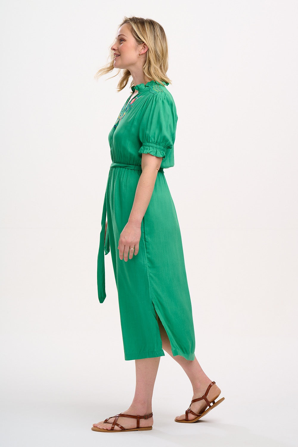 Boho style summer midi dress from SUGARHILL BRIGHTON in a vibrant shade of green. It has a relaxed cut and comes with a self-fabric belt, short sleeves with shirred frill cuffs, shirring on the shoulders, a flattering V-neck adorned with delicate floral embroidery.l and pockets.