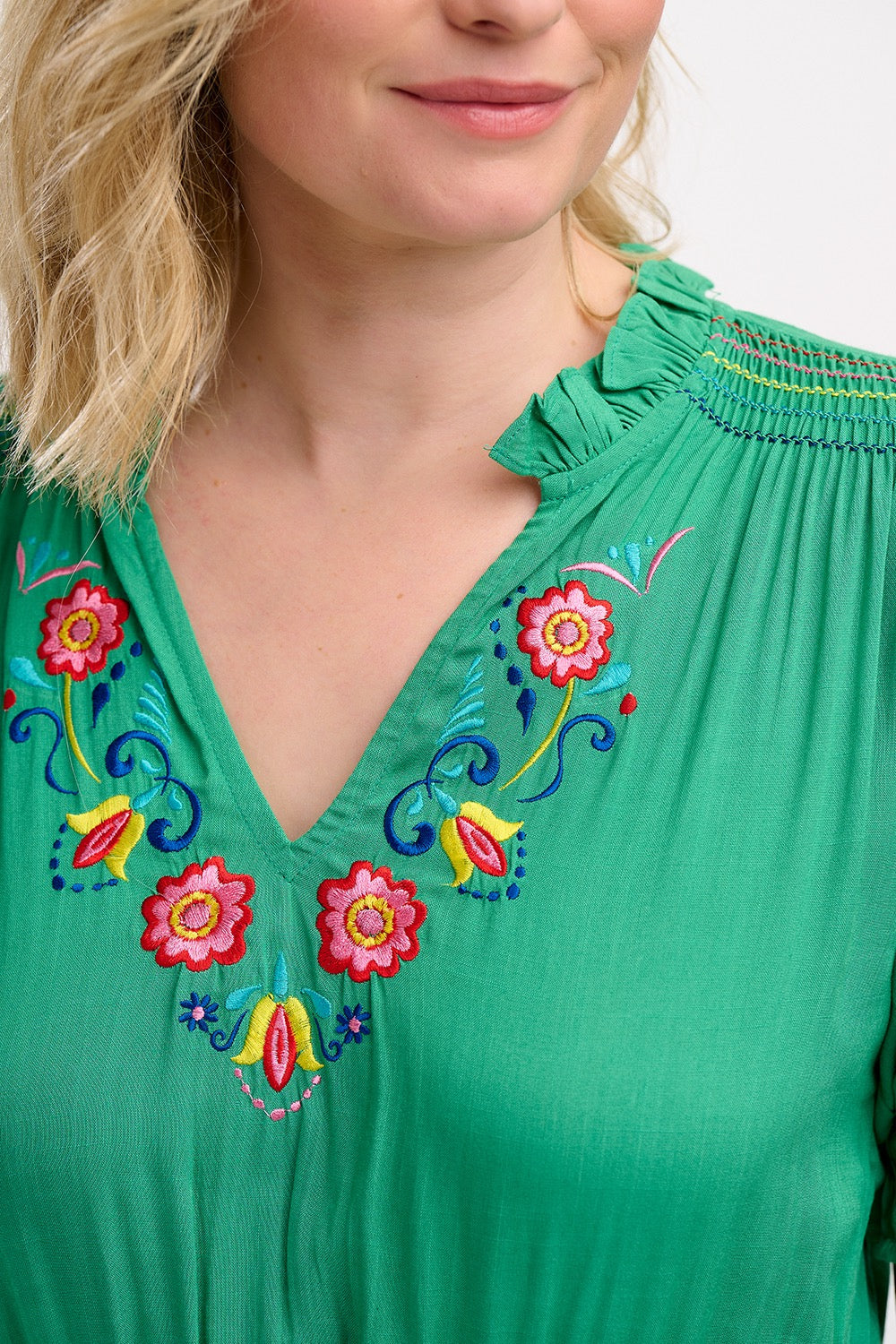 Boho style summer midi dress from SUGARHILL BRIGHTON in a vibrant shade of green. It has a relaxed cut and comes with a self-fabric belt, short sleeves with shirred frill cuffs, shirring on the shoulders, a flattering V-neck adorned with delicate floral embroidery.l and pockets.