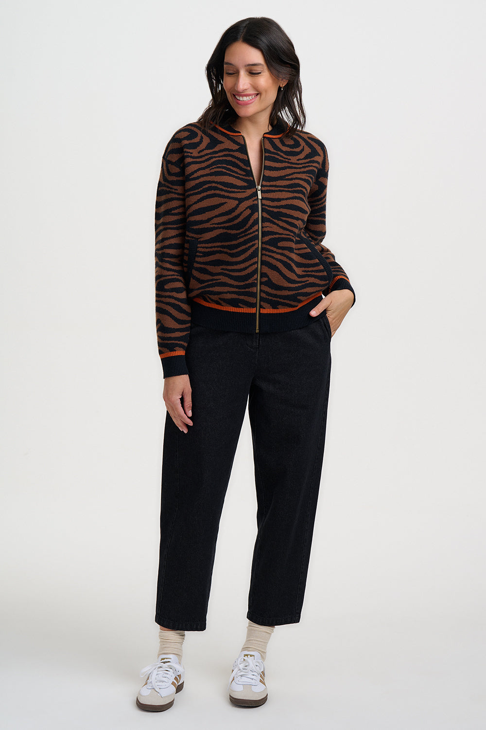 Woman wearing the tiger print jacket Solana from Sugarhill Brighton and black pants on a white background